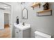 Bathroom featuring a single sink vanity, modern mirror and wood-style floors at 1219 Aladdin Rd, Spring Hill, FL 34609