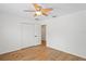 Bedroom features hardwood flooring, ceiling fan, and closet at 1219 Aladdin Rd, Spring Hill, FL 34609