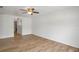 Bedroom featuring wood-look floors, a ceiling fan and a view into another room through an arched entryway at 1219 Aladdin Rd, Spring Hill, FL 34609