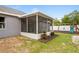 Exterior view of home with screened lanai and backyard playset at 1219 Aladdin Rd, Spring Hill, FL 34609