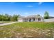 Charming single-story home featuring a well-manicured lawn, attached garage, and freshly painted exterior at 1219 Aladdin Rd, Spring Hill, FL 34609