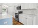 Kitchen with stainless steel range and microwave, complemented by subway tile backsplash at 1219 Aladdin Rd, Spring Hill, FL 34609