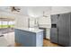 Eat-in kitchen featuring stainless steel refrigerator, breakfast bar, and bright natural light at 1219 Aladdin Rd, Spring Hill, FL 34609