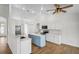 Open-concept kitchen featuring white cabinetry, stainless appliances, subway tile backsplash, and wood floors at 1219 Aladdin Rd, Spring Hill, FL 34609