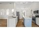 Spacious kitchen with stainless steel appliances, center island, and stylish wood-look flooring at 1219 Aladdin Rd, Spring Hill, FL 34609