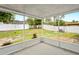 View of an enclosed and screened lanai overlooking the spacious backyard and white vinyl fence at 1219 Aladdin Rd, Spring Hill, FL 34609