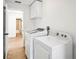 Bright laundry room with a washer, dryer, and ample storage space at 1219 Aladdin Rd, Spring Hill, FL 34609