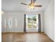 Sunlit living room showcasing a decorative front door, a window with backyard views and wood-look floors at 1219 Aladdin Rd, Spring Hill, FL 34609