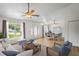 Open concept living and dining area featuring tile flooring, modern furniture, and a view of the outside at 1219 Aladdin Rd, Spring Hill, FL 34609