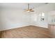 An open room with wood floors, a ceiling fan, decorative niches and arched entryway into an adjacent room at 1219 Aladdin Rd, Spring Hill, FL 34609