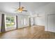 Open concept living room with modern lighting and neutral paint, seamlessly connected to dining area at 1219 Aladdin Rd, Spring Hill, FL 34609