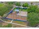 A neighborhood playground featuring swings, slides, and picnic area surrounded by trees and a safety fence at 1219 Aladdin Rd, Spring Hill, FL 34609