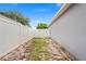 View of the side yard featuring a white fence and a gate at 1219 Aladdin Rd, Spring Hill, FL 34609