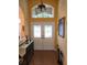 Inviting foyer with a tiled floor, decorative double doors, and a transom window letting in natural light at 12270 Clarendon Ct, Spring Hill, FL 34609