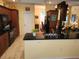 Kitchen with a black appliance set, dark-wood cabinetry, granite countertops and a view into the dining room at 12270 Clarendon Ct, Spring Hill, FL 34609