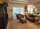 The living room includes plush sofas and a sliding glass door to the patio, perfect for indoor/outdoor living at 12270 Clarendon Ct, Spring Hill, FL 34609