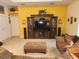 Living room showcasing a media center, plush sofas, and an ottoman, perfect for relaxation and entertainment at 12270 Clarendon Ct, Spring Hill, FL 34609