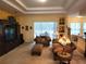The living room features a cozy seating area with plush sofas and a sliding glass door to the outside at 12270 Clarendon Ct, Spring Hill, FL 34609