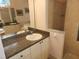 Main bathroom with tiled shower, granite counters and large mirror at 12270 Clarendon Ct, Spring Hill, FL 34609