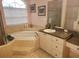 Bright main bathroom with soaking tub, granite counters and tiled shower at 12270 Clarendon Ct, Spring Hill, FL 34609