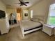Light and bright main bedroom with large windows, carpeted floors, and ensuite bathroom at 12270 Clarendon Ct, Spring Hill, FL 34609