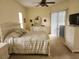 Bright main bedroom with ceiling fan, dresser, and sliding door access to the exterior at 12270 Clarendon Ct, Spring Hill, FL 34609