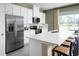Modern kitchen featuring white cabinetry, stainless steel appliances, and spacious quartz countertop island with seating at 12420 Amber Creek Cir, Lakewood Ranch, FL 34211