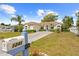 Beautifully landscaped single-story home featuring a manicured lawn, lovely mailbox, and an extended driveway at 1245 Coble E Rd, Spring Hill, FL 34608