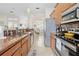 Open-concept kitchen with granite countertops and stainless steel appliances overlooking the dining room at 1245 Coble E Rd, Spring Hill, FL 34608