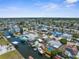A panoramic aerial showcases the canal-front homes with boat docks, pools, and lush landscaping at 13411 Lisa Dr, Hudson, FL 34667