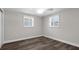 Clean bedroom with light walls, white trim, and wood style flooring at 13411 Lisa Dr, Hudson, FL 34667