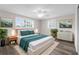 Beautiful bedroom with light walls, wood style floors, and a ceiling fan over the bed at 13411 Lisa Dr, Hudson, FL 34667