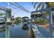Waterfront property featuring a private boat dock and lift, offering direct access to the open water at 13411 Lisa Dr, Hudson, FL 34667