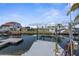 Waterfront property featuring a private boat dock and lift, offering direct access to the open water at 13411 Lisa Dr, Hudson, FL 34667