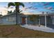 Charming one-story home featuring a covered entry, mature palm trees, and well-maintained landscaping at 13411 Lisa Dr, Hudson, FL 34667