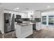 Updated kitchen featuring stainless steel appliances, island, and ample storage, sliding glass doors leading to the patio at 13411 Lisa Dr, Hudson, FL 34667