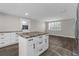 Bright kitchen featuring an island with a marbled countertop, plenty of storage, and stainless steel appliances at 13411 Lisa Dr, Hudson, FL 34667