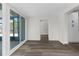 Living room with wood style floors and a large sliding glass door at 13411 Lisa Dr, Hudson, FL 34667