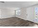 Bright living room featuring sleek new flooring, fresh paint, and a large window with natural light at 13411 Lisa Dr, Hudson, FL 34667