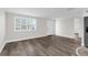 Bright living room featuring sleek new flooring, fresh paint, and a large window with natural light at 13411 Lisa Dr, Hudson, FL 34667
