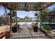 A cozy patio with a pergola, overlooking the serene canal and waterfront at 13411 Lisa Dr, Hudson, FL 34667