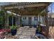 Charming patio area with a wooden pergola, lush plants, and a peaceful outdoor setting at 13411 Lisa Dr, Hudson, FL 34667
