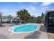 Inviting backyard pool featuring a dolphin statue with dock and canal views at 13411 Lisa Dr, Hudson, FL 34667