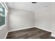 Room with a window, wood style floors, and white walls with trim at 13411 Lisa Dr, Hudson, FL 34667