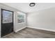 Room with a black door, wood style floors and two windows in view at 13411 Lisa Dr, Hudson, FL 34667