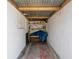 Indoor storage space with open shelving, a metal roof, and white painted walls at 13411 Lisa Dr, Hudson, FL 34667