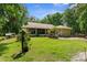 Expansive backyard with a screened-in porch, wood deck, and lush greenery at 14145 Citrus Way, Brooksville, FL 34601