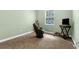 A large room with carpet, a wooden rocking chair and side table at 14145 Citrus Way, Brooksville, FL 34601
