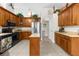Well-equipped kitchen featuring wood cabinets, stainless steel appliances, and a functional center island at 14145 Citrus Way, Brooksville, FL 34601