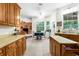 Warm kitchen with a large window, wooden cabinets, and a sunny breakfast nook for casual dining at 14145 Citrus Way, Brooksville, FL 34601